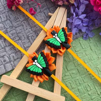 A beautiful butterfly hairclip Rakhi combo with orange flower based