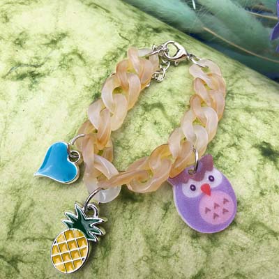 A beautiful bracelet Rakhi with owl, pineapple, heart