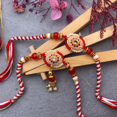 Elegant Pink & Red Bhaiya Bhabhi Rakhi Set - Kundan & Pearl Rakhi for Brother & Bhabhi