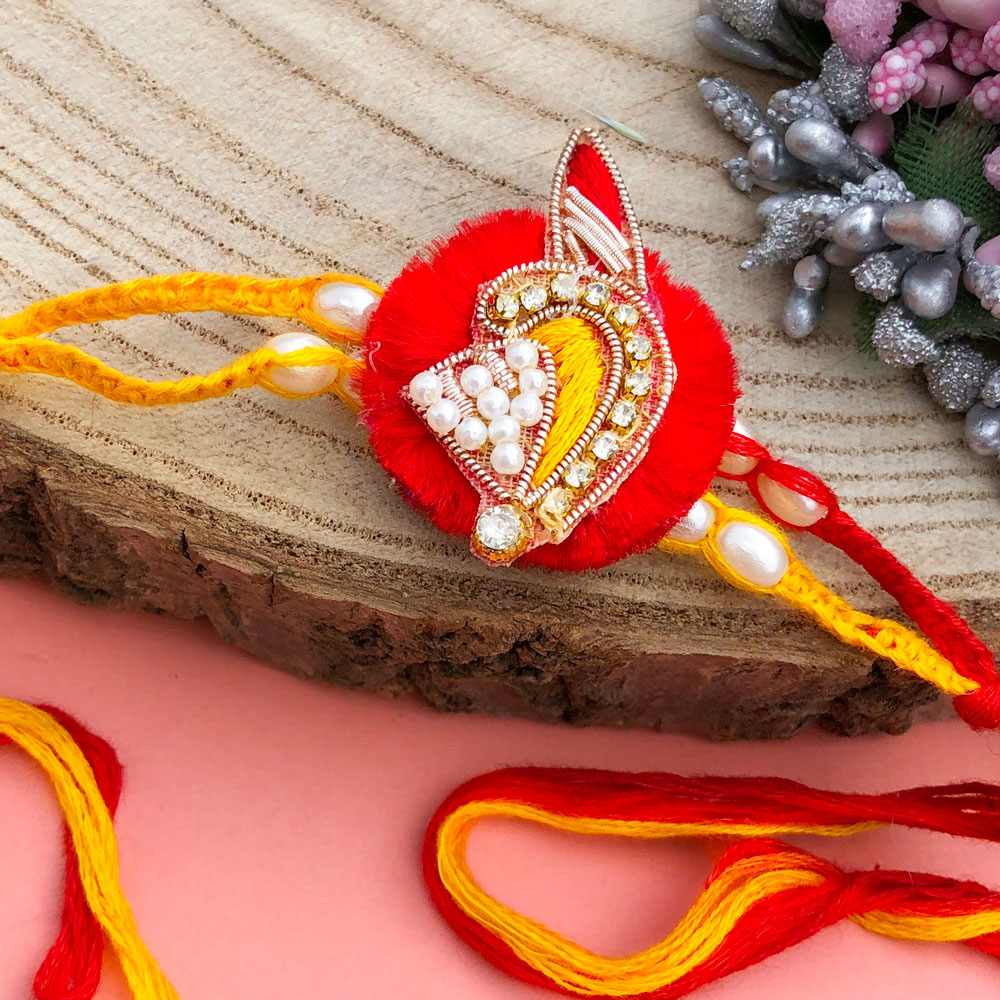 designer piece of red base thread Rakhi for brother