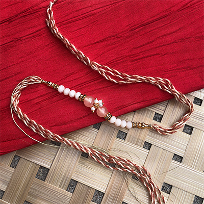 Simple wear traditional peach Dora Rakhi for brother 