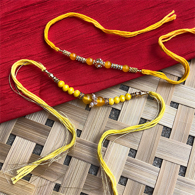 Simple n classy yellow Dora Rakhi combo for bhaiya bhabhi