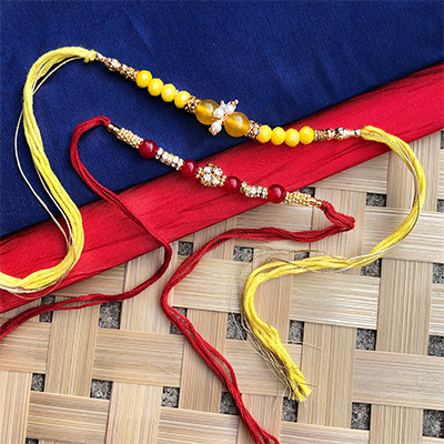 lovely Red, yellow Dora Rakhi combo for bhaiya, bhabhi