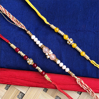 Auspicious pearl beads Dora Rakhi set of 3 for bhaiya n bhabhi