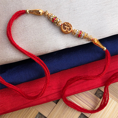 Blessings ful Om Design Golden Pearl dora Rakhi For bhabhi