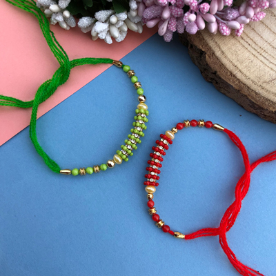 simple sober classy looking green and Red Dora Rakhi combo