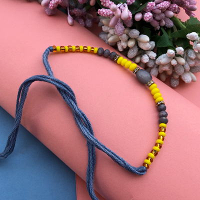 Any time wear awesome yellow and grey pearl Dora Rakhi