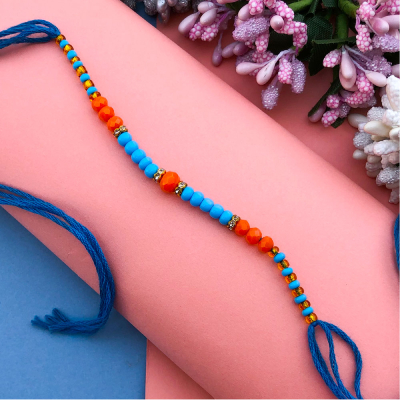 Precious orange and sky pearl Dora Rakhi for bhaiya& bhabhi