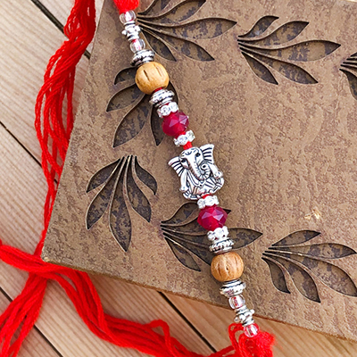 Mesmerizing Beads & Diamond Silver Ganpati Rakhi for Bhaiya