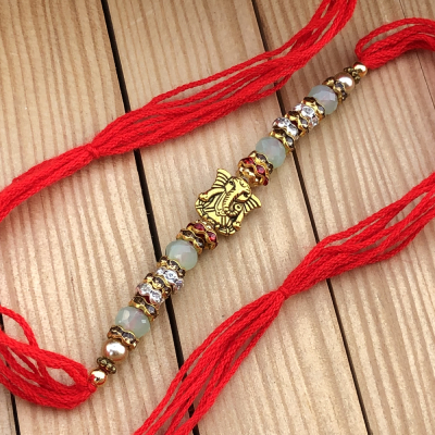 Exuberant Gold Ganpati Rakhi Set for Raksha Bandhan