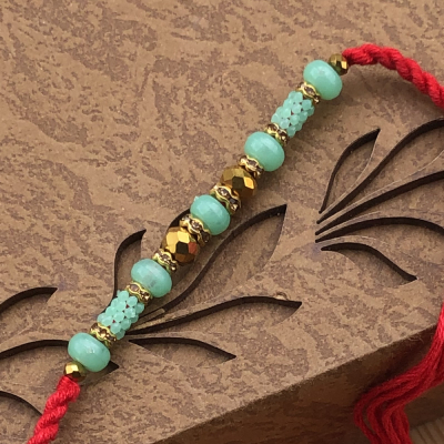 Resplendent Green Pearls & Gold Rings Rakhi for Bhai