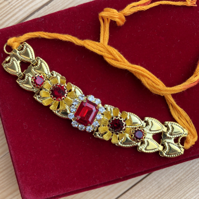 Exquisite Flower Design Studded Red Stones Golden Rakhi for Bhaiya