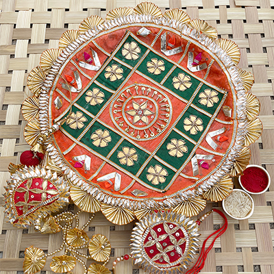 Traditional look orange and Green base pooja thali with bhaiya bhabhi Rakhi set