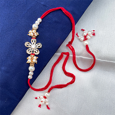 Designer flower shape white pearl Dora rakhi for bhaiya